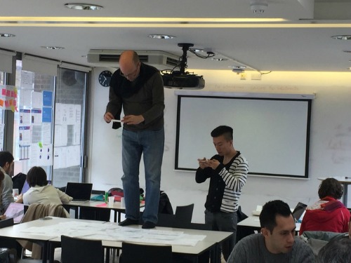 Ben standing on a table taking photos