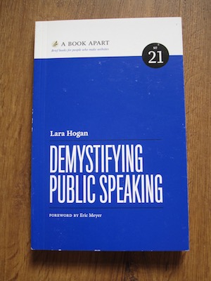 Book cover of <i>Demystifying Public Speaking</i> by Lara Hogan.