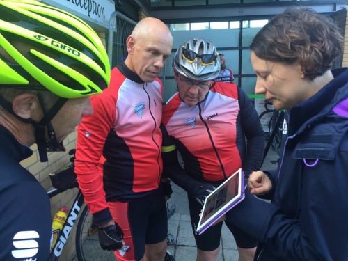 Photo of a group of cyclists helping