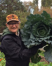 Head shot of Frances Gant holding a massive cabbage